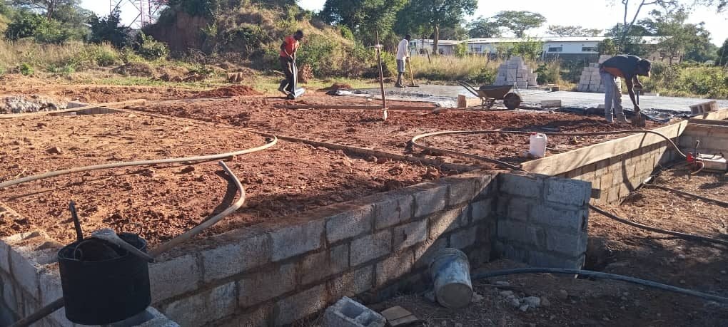 Foundation walls complete and backfilling under way