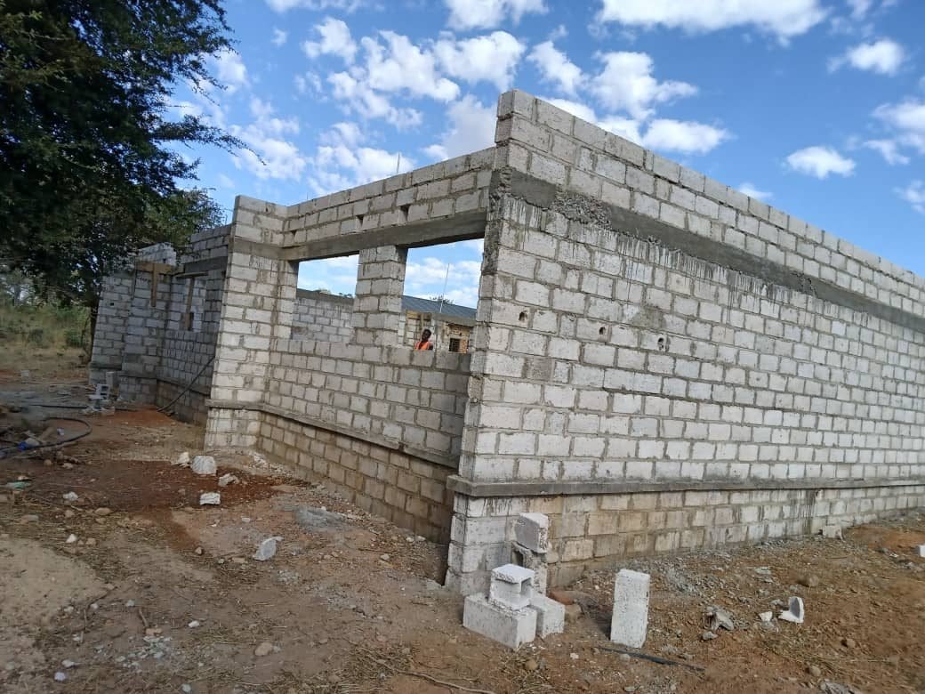 Block walls rising at the corner of the new building