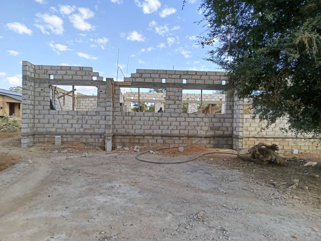 The long elevation with window openings and lintels in place