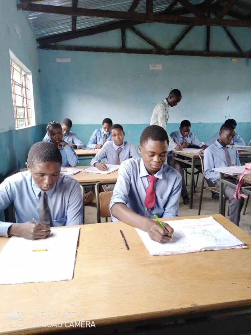 Secondary school students sitting examinations in class